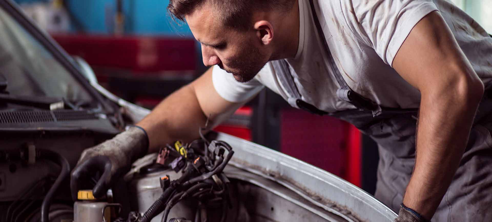 Mechanic inspecting an engine bay