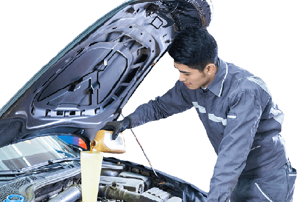 Technician adding engine oil through a funnel under an open hood