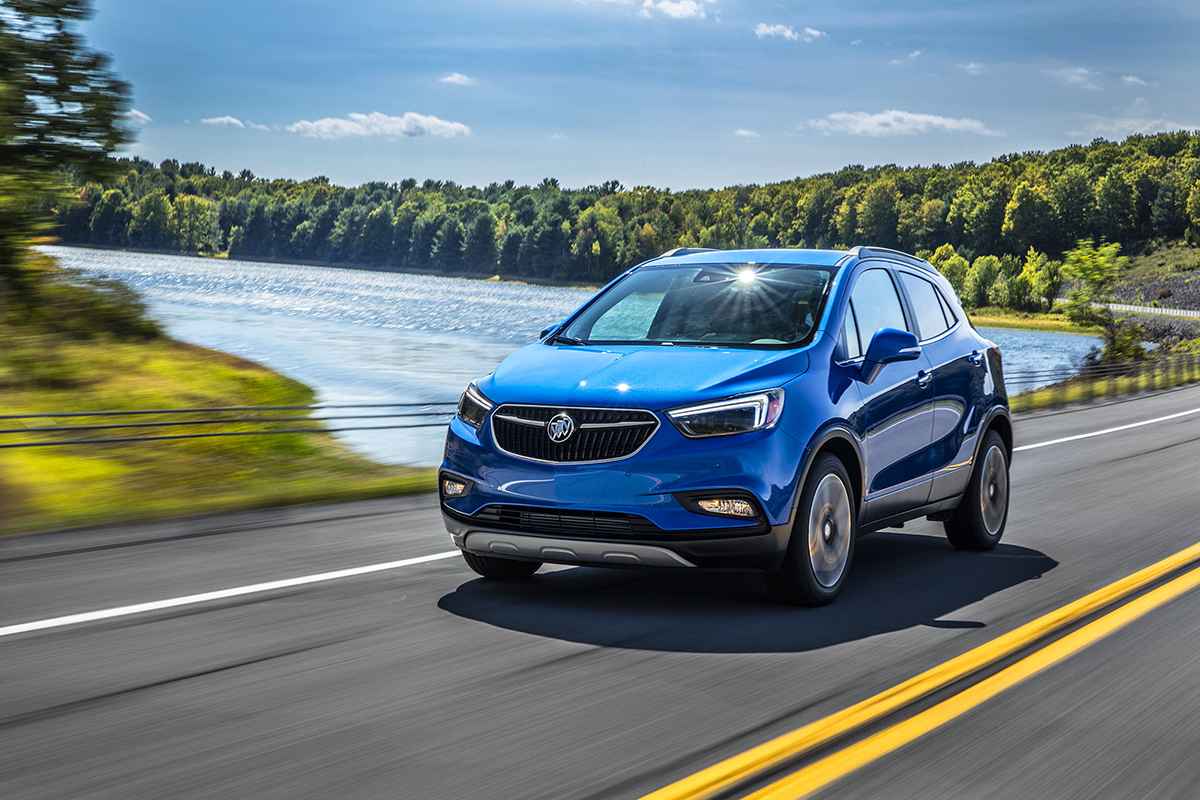Blue Buick Encore on a road beside a lake