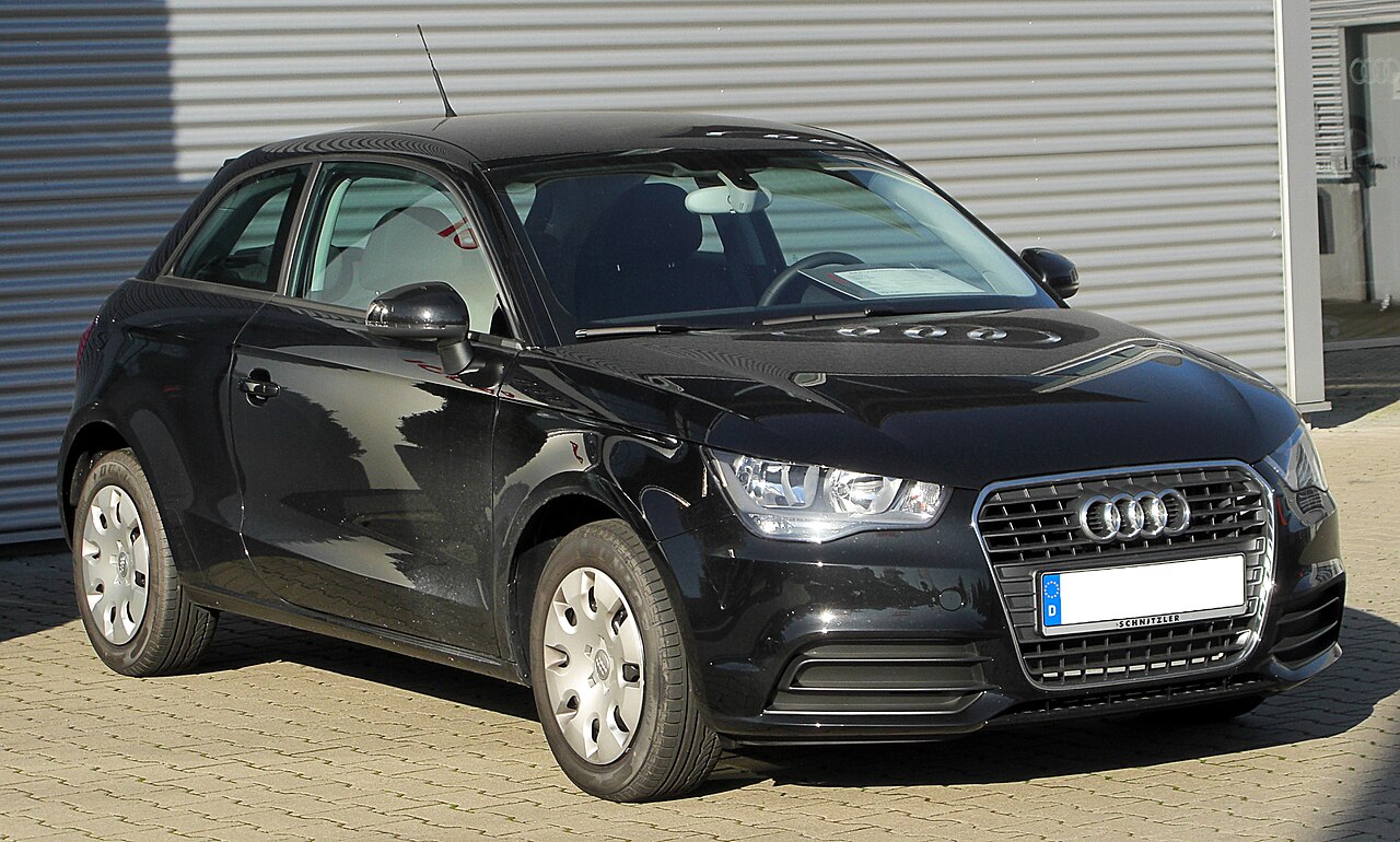 Black first-generation Audi A1 hatchback viewed from the front