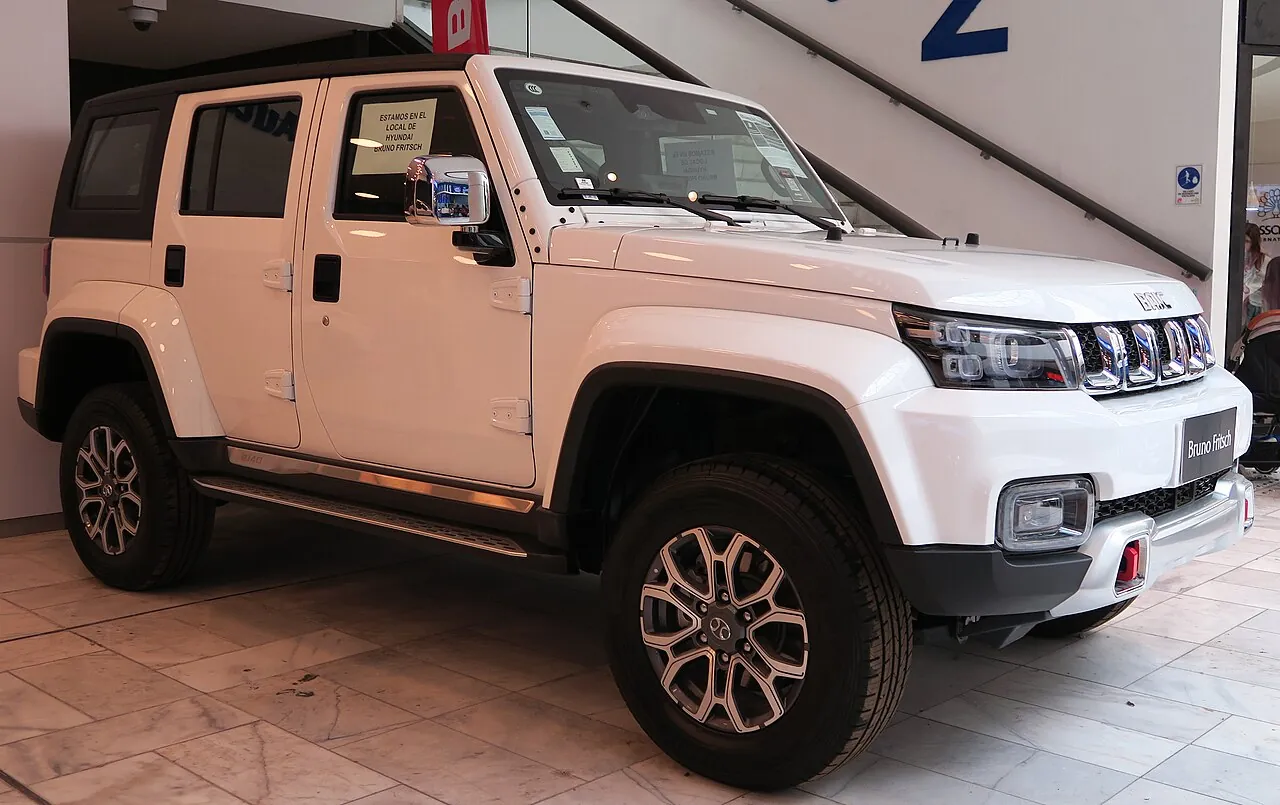 White BAIC BJ40 Plus on an indoor vehicle display