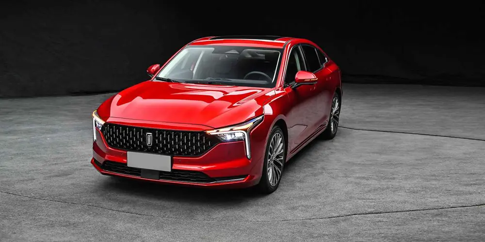 Red Bestune B70 sedan viewed from the front in a studio setting
