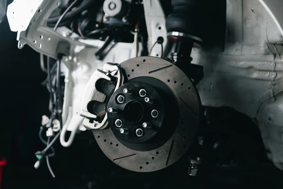 Brake disc, caliper and suspension visible during a wheel-off inspection