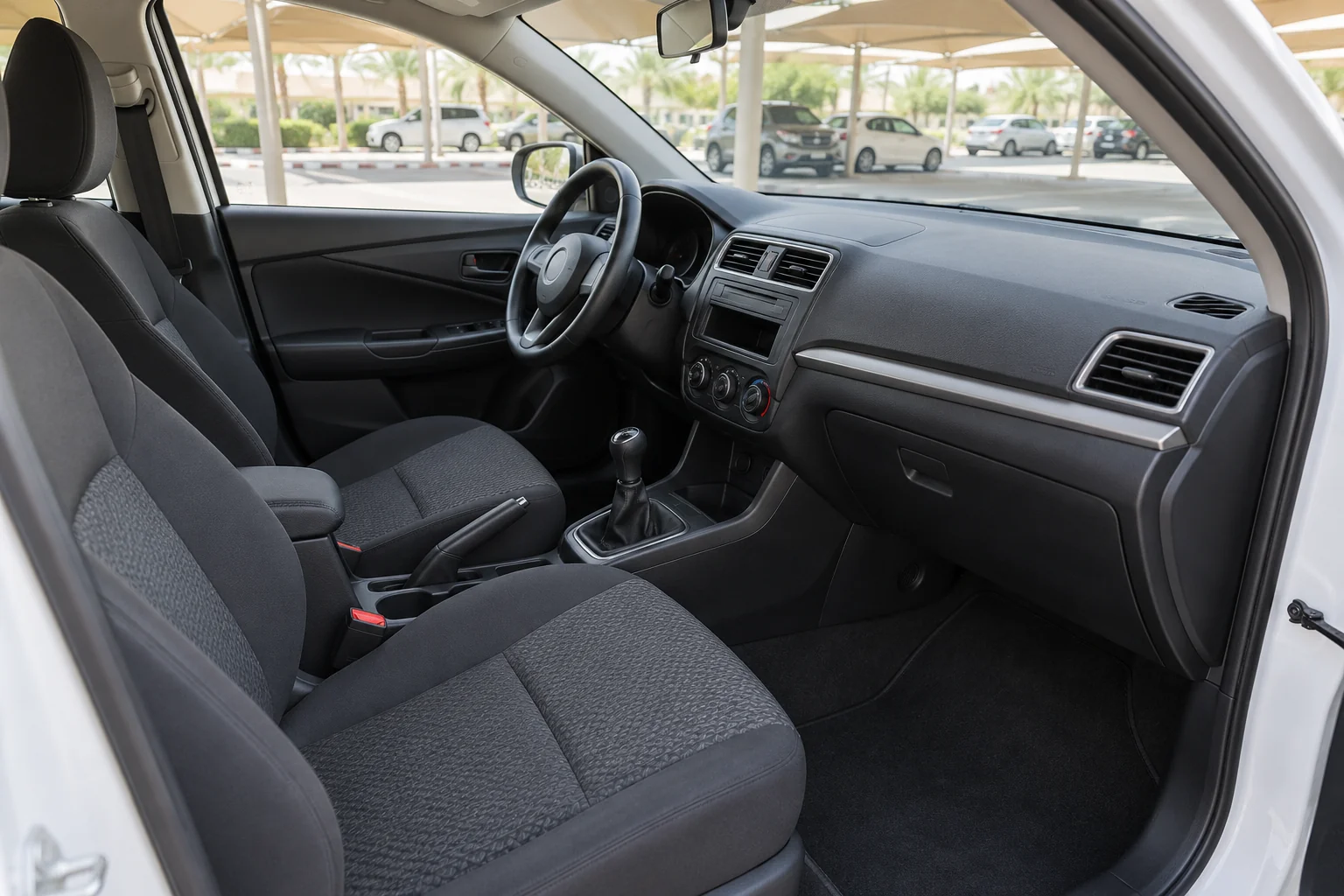 Fabric front seats and manual air-conditioning controls in a compact left-hand-drive car