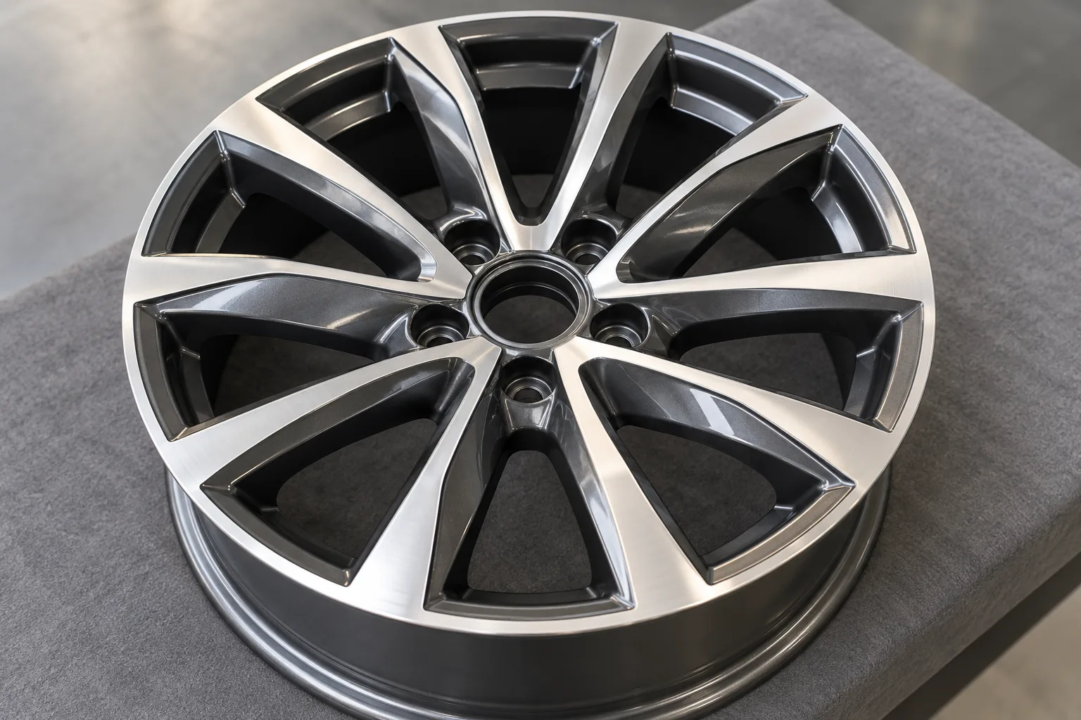 Alloy wheel with bright machined-style faces and graphite recesses