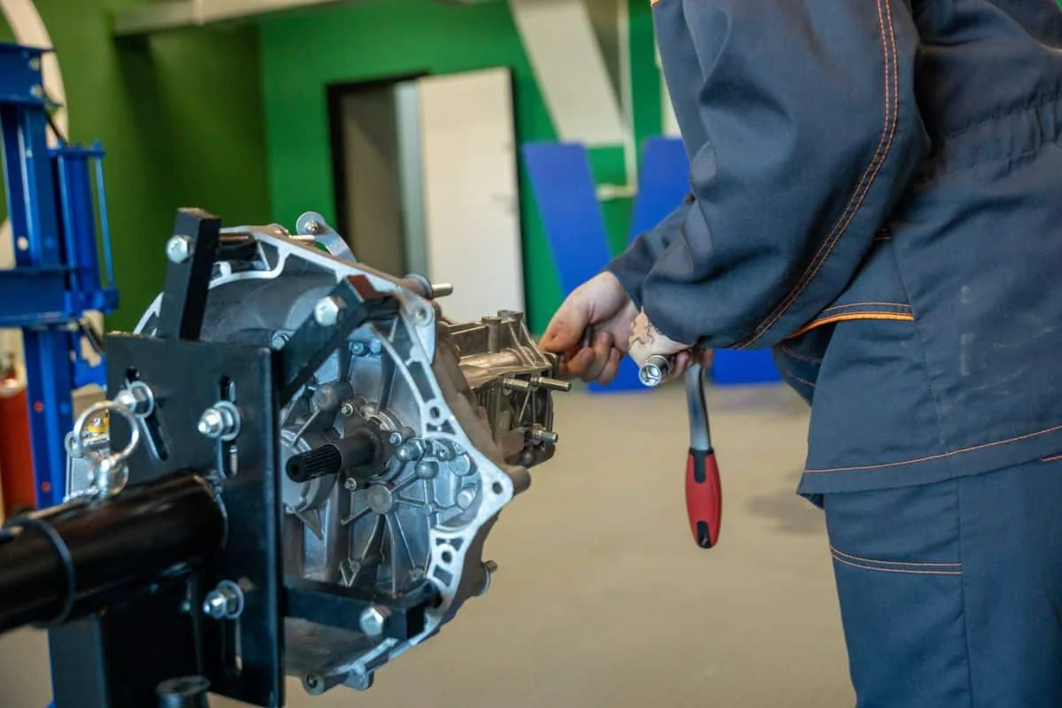 Technician working on a removed gearbox