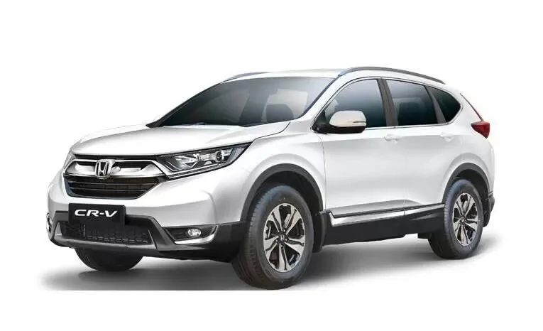 Older white Honda CR-V shown from the front and side
