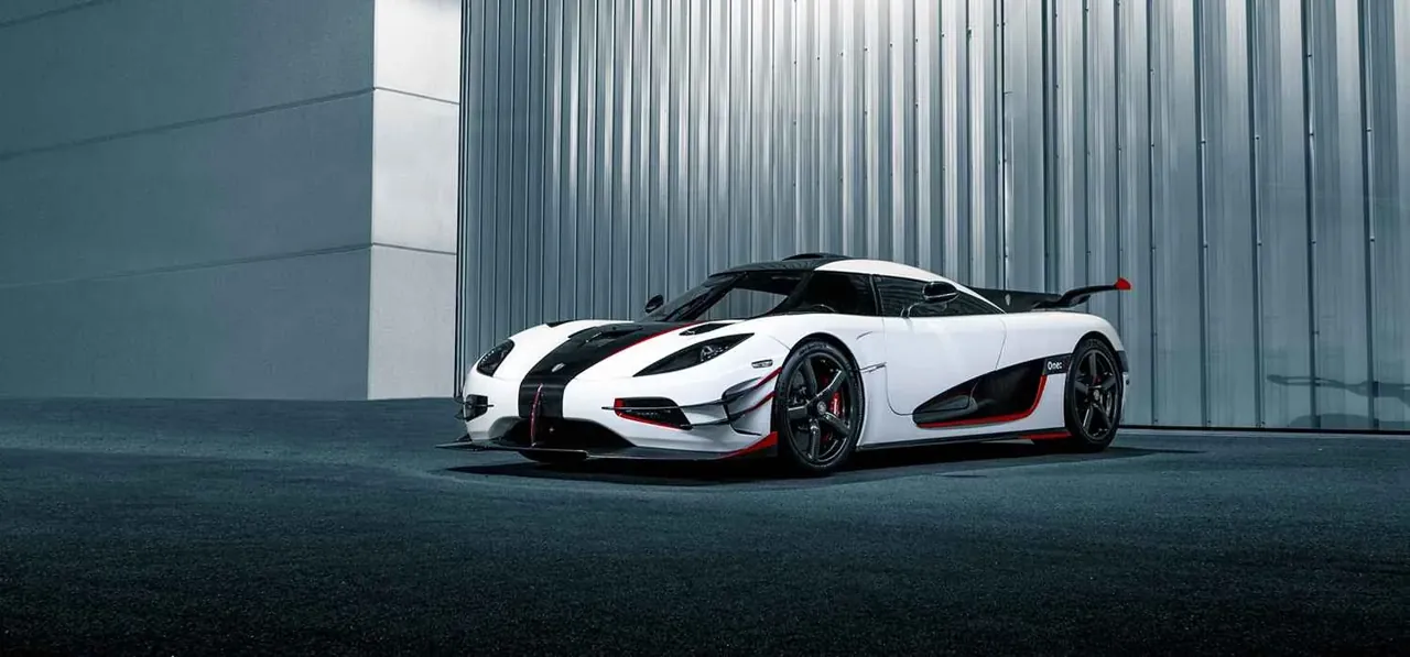 White Koenigsegg One 1 parked beside a building