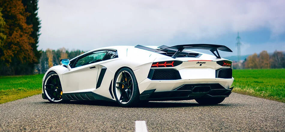 White Lamborghini Aventador parked on a road