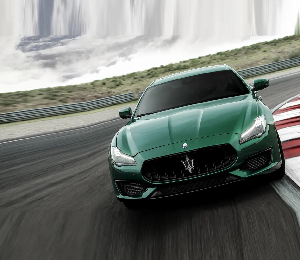 Green Maserati Quattroporte photographed on a circuit