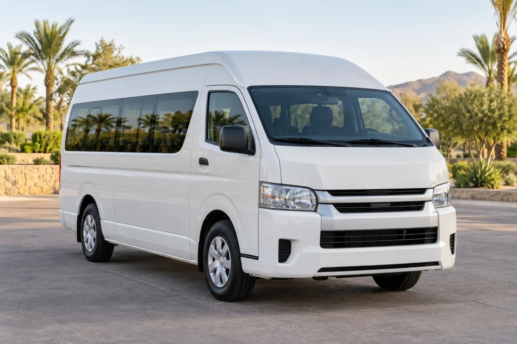 White passenger minibus parked on a paved forecourt