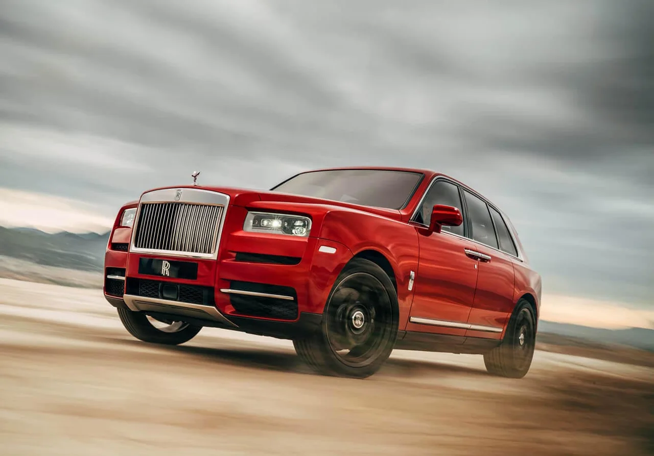 Red Rolls-Royce Cullinan viewed from the front and side