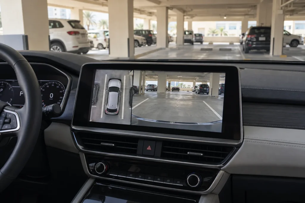 Dashboard screen showing a surround-view parking image beside a camera view