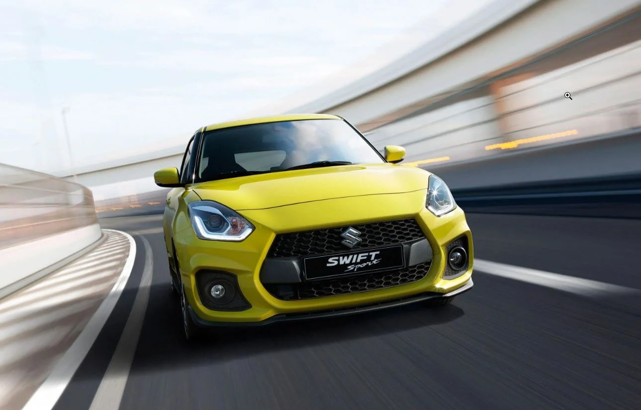 Yellow Suzuki Swift Sport on a road