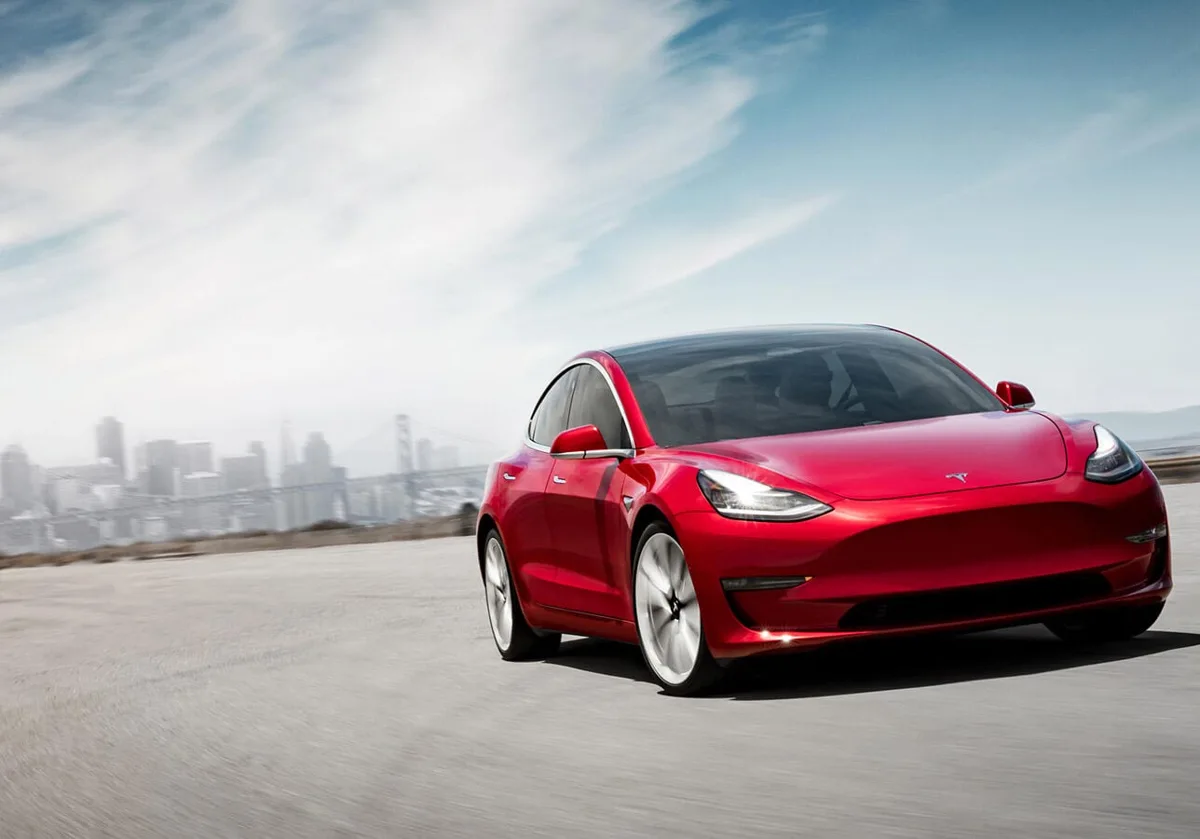 Red Tesla Model 3 viewed from the front