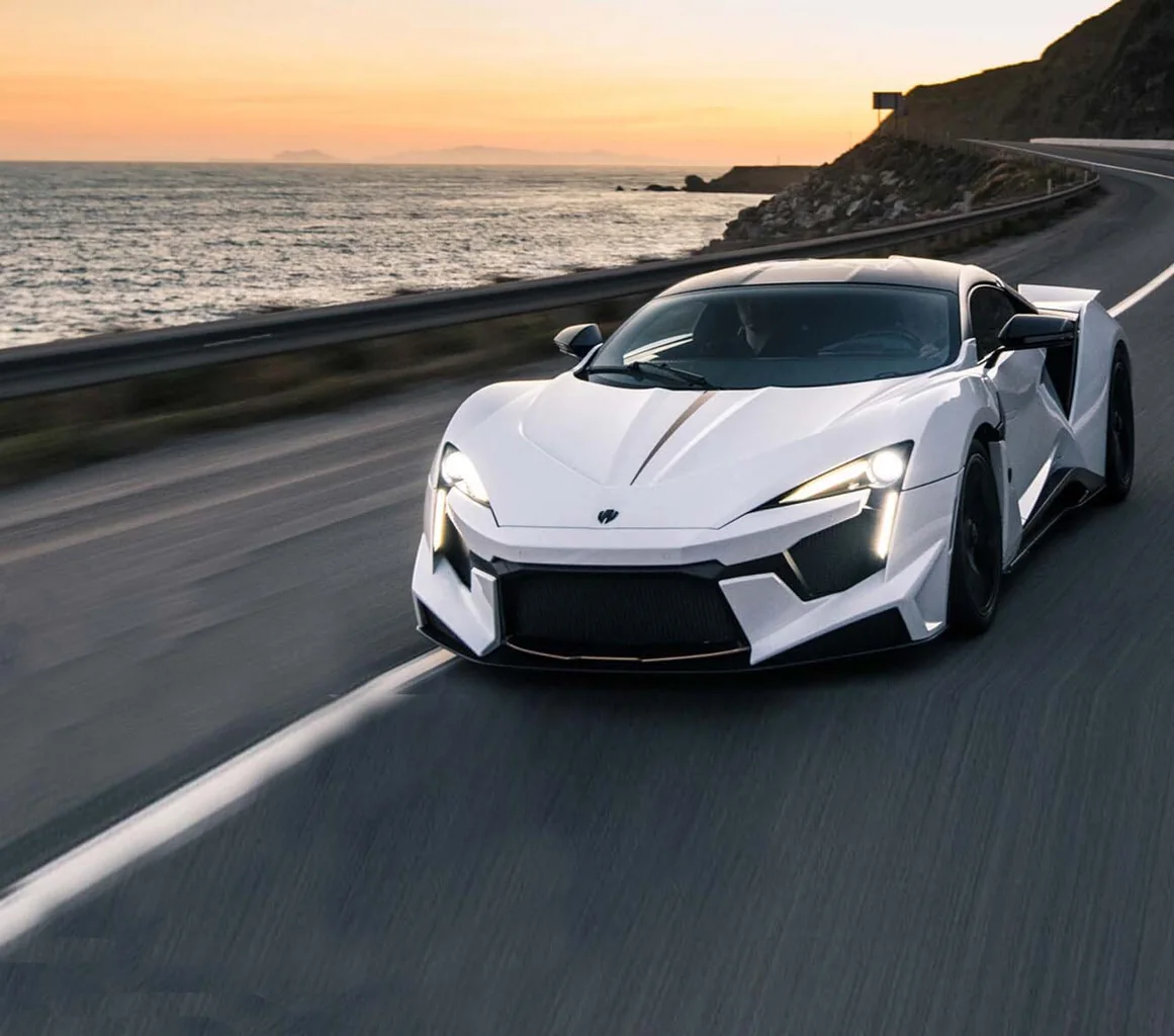 White Fenyr SuperSport traveling along a coastal road
