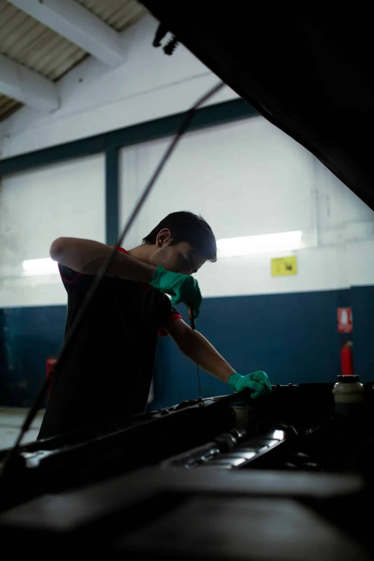 Technician checking an engine oil dipstick